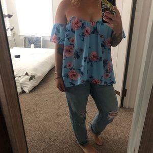 Light blue, flowery off the shoulder blouse.